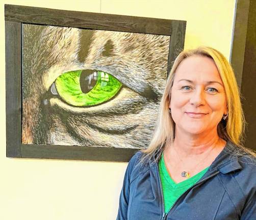 Deidre Ellis with her painting of a cat’s eye.