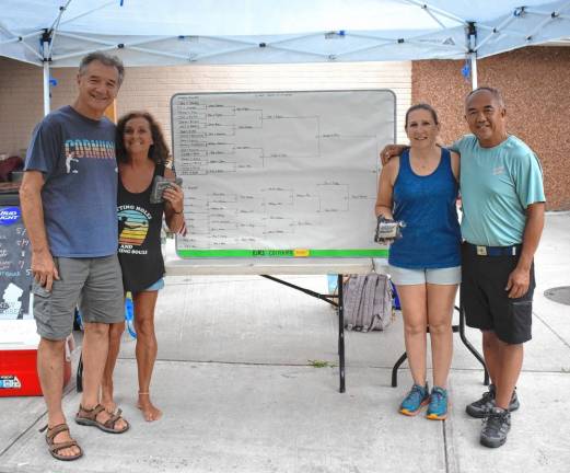 John and Gwen Storms, left, won first place and Sue and Erwin Wong took second place in the tournament.