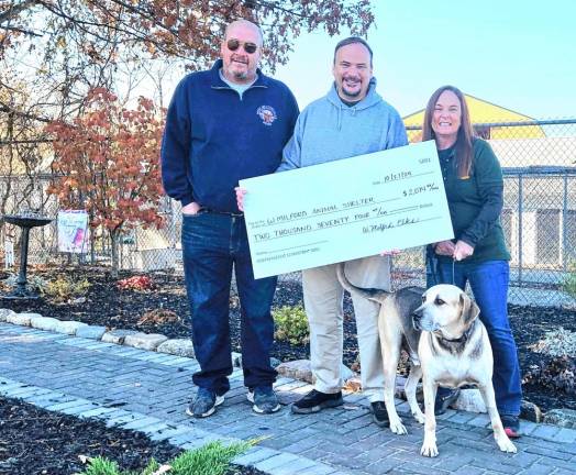 From left are Kevin Goodsir, Doug Weed and Robin Logan with her recently adopted dog, Clark. (Photo provided)