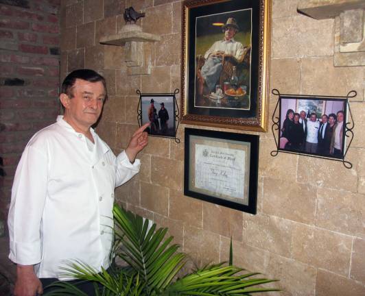 Photo by Roger Gavan Celebrity and award-winning chef Tony Kolaj, co-owner of Al Laghetto, points to a photograph with his &igrave;fishing buddy,&icirc; actor and comedian Bill Murray.