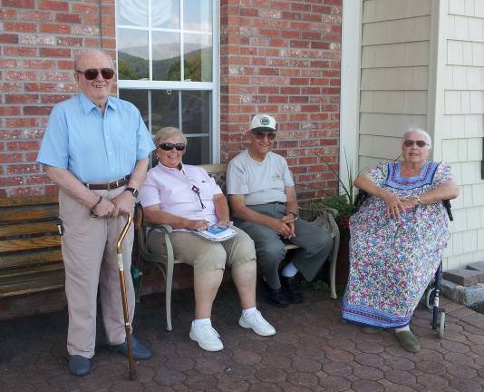 In front of the building, on the stoop, are George Goldberg, Barbara Carcich, Victor and Maureen DeGeorge.