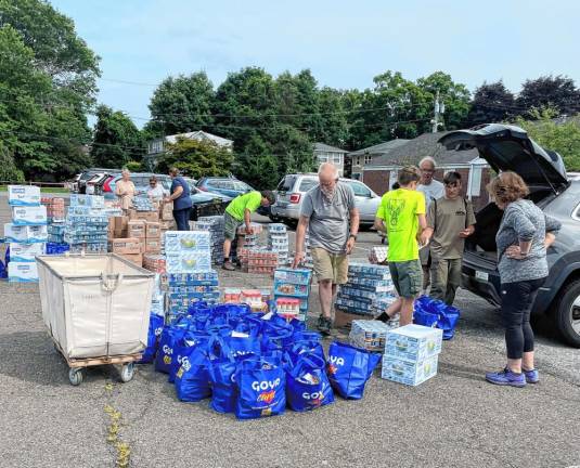 SC2 Representatives of local food pantries pick up donated items at Our Lady Queen of Peace Roman Catholic Church in Hewitt.