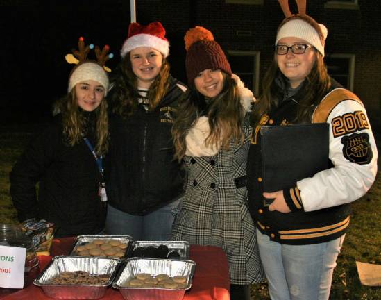 Olivia Dell&#x2019;olio, 17, Brianne Dowling, 17, Victoria Meier, 17, and Brianna Vierng, 17, help with refreshments during the tree lighting ceremony at the Municipal Building Monday night.