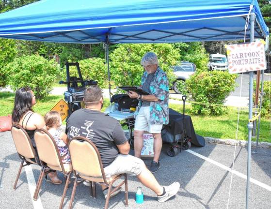 A family sits for caricaturist Steve Lefkowitz.