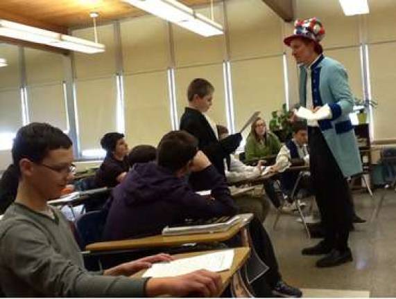 Social studies teacher Gregory Zackaroff debates with one of his delegates during the Constitutional Convention.