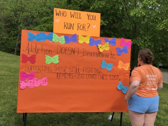 Participants wrote the names of people for whom they were running and messages on a posterboard.