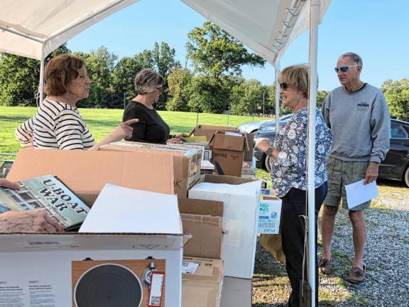 Residents donate books for the sale.