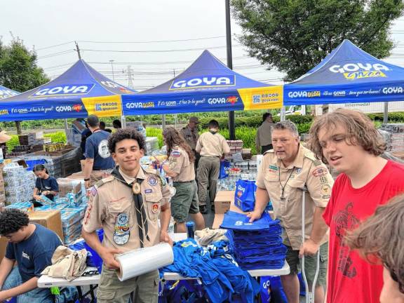 Scouts with Troop 159 in Hewitt fill bags at Goya Foods’ headquarters in Jersey City.