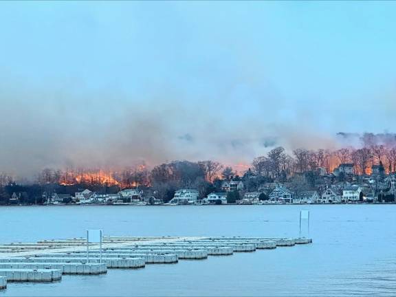 Flames can be seen across Greenwood Lake about 5 p.m. Sunday, Nov. 10. The photo was taken near D’Boathaus on the west side of the lake. (Photo by Denise von Wilke)