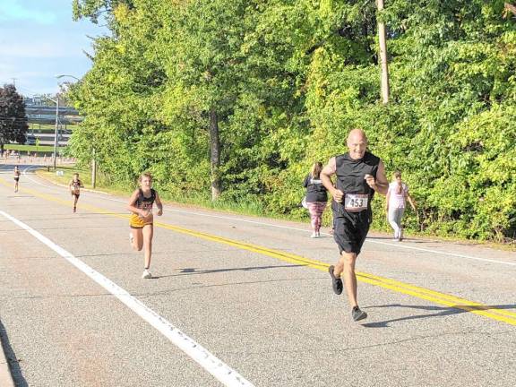 Boy wins 5K benefiting schools