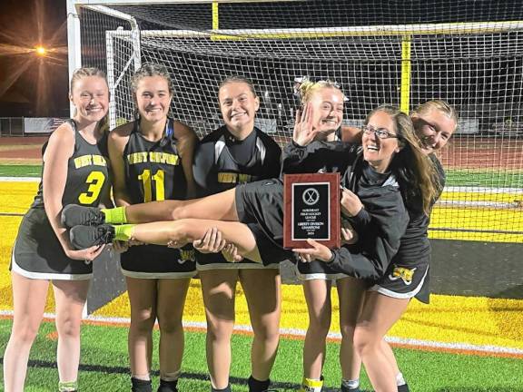 FH1 West Milford High School field hockey team members hold up their head coach, Krista Provost. (Photo provided)