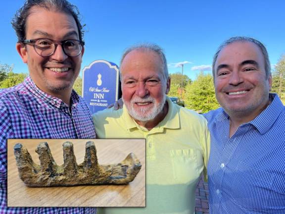 Alejandro and Joe Jr. flank their dad Joe Santandrea. The three men found an interesting artifact while out metal detecting.