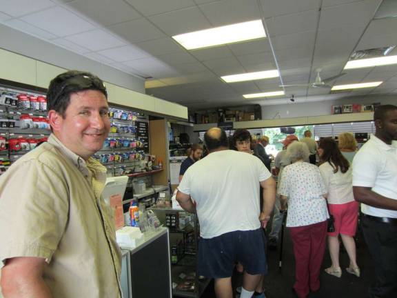 Stu Feldman, left, vice president of the West Milford Chamber of Commerce, looked pleased as the Cash Mob descended on Computer Discount of NJ last Saturday.