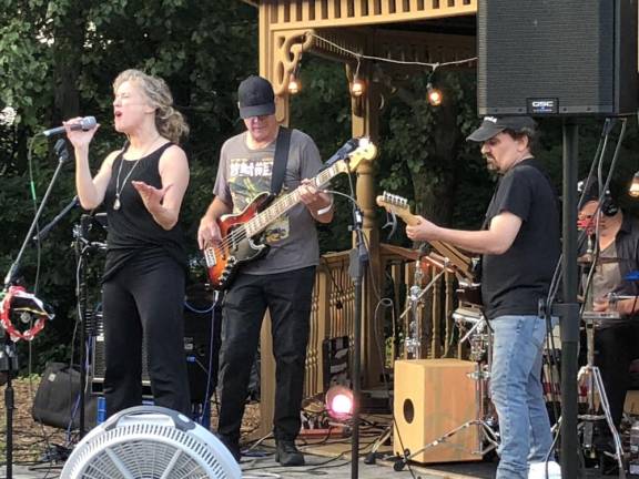 OC2 OCD, which stands for One Chick with Dudes, performs Thursday, July 20 at the Bubbling Springs Gazebo. Amy Goff is the lead singer. From left, Dave Faulkner plays bass, Vinnie DeMasi is on guitar and Chuck Burgi is on drums. (Photos by Kathy Shwiff)