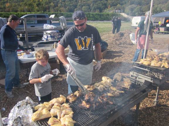 The West Milford Presbyterian Church hosts its famous barbeque during the festival. Here, J.T. does the honors.