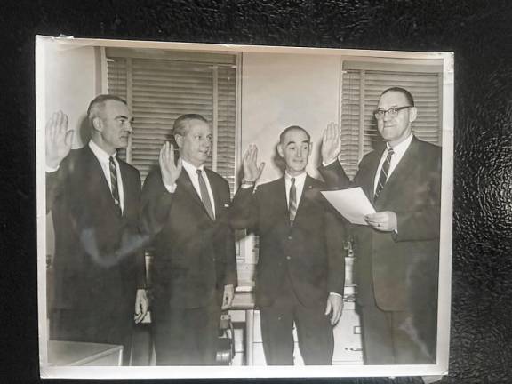 From left, Gilbert Terhune, Wilbur Fredericks and Robert Little are sworn in to council terms in the 1960s by the township clerk, George Eckhardt. (File photo by Ann Genader)