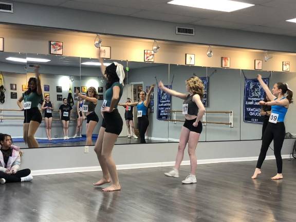 Girls, ages 13-18, perform in front of a mirror at Trinity Studios in Sparta.