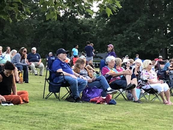 OC5 Residents bring chairs to set up on the lawn. The summer concert series concludes Thursday, Aug. 3 with Country Comfort.