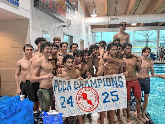 PC2 Members of the Passaic County Technical Institute swim teams hold the Passaic County Coaches Association championship banner. (Photos provided)