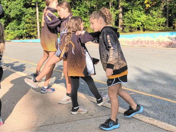 Members of the Jr. Highlander Track Club warm up before the race.