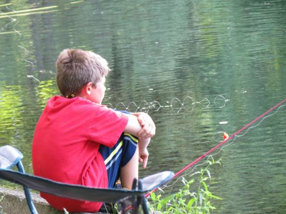Chris enjoyed the relaxation of fishing by the pond.