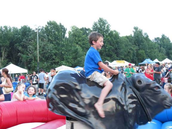 Seven-year-old Eddie did his best on the mechanical bull. This was one of the most fun attractions at Thunder. Kids lined up to take their turn.
