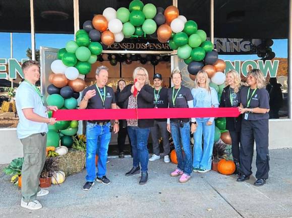 CD2 Mayor Michele Dale cuts a ribbon with owners Glenn Liebau and Michele Losefsky and staff members Saturday, Oct. 19.