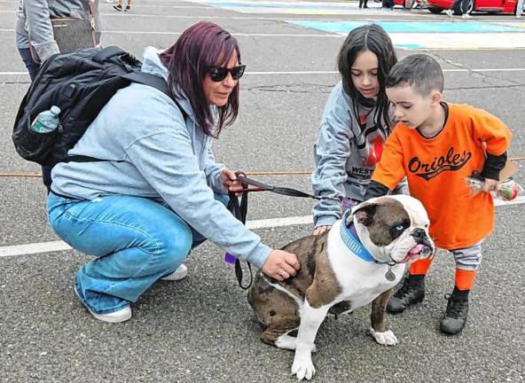Young children pet Lily, a dog adopted by West Milford Animal Shelter volunteer Andrea DeSalvia, left.