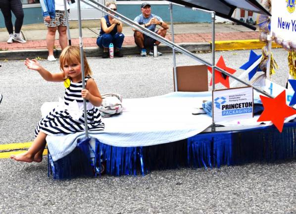 Aubrey Boula, granddaughter of Lions Club member Nancy Clifford, rides in the parade.