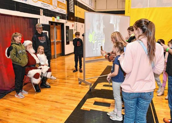 Children pose for photos with Santa before the wrestling begins.