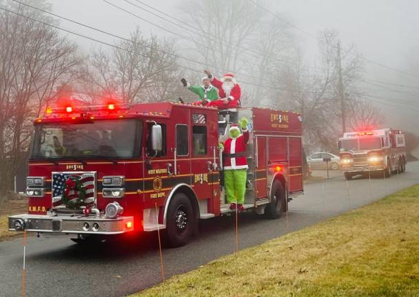 Members of the Upper Greenwood Lake Volunteer Fire Company escort Santa, along with his trusty Elf and the Grinch, around the area on Engine 5. (Photo provided)