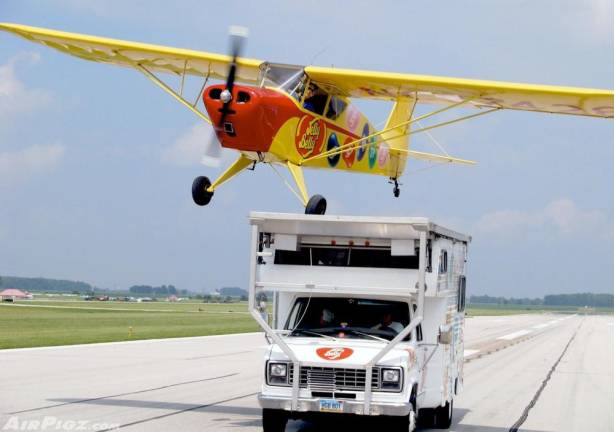 Kent Pietsch lands his plance on a moving recreational vehicle.