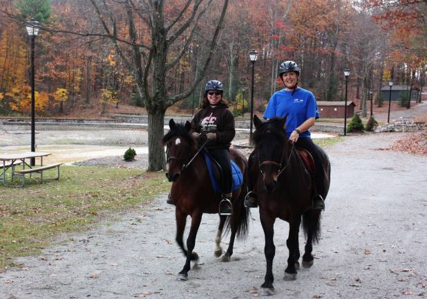 Enjoying all that's beautiful in West Milford in the fall, Zoey Schilling, left, and Denise Lambros take a slow ride around Bubbling Springs Park paths. Photo by Ginny Raue