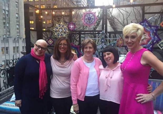 Michelle Fenwick, second from left, stands with her pink power team of cancer survivors.