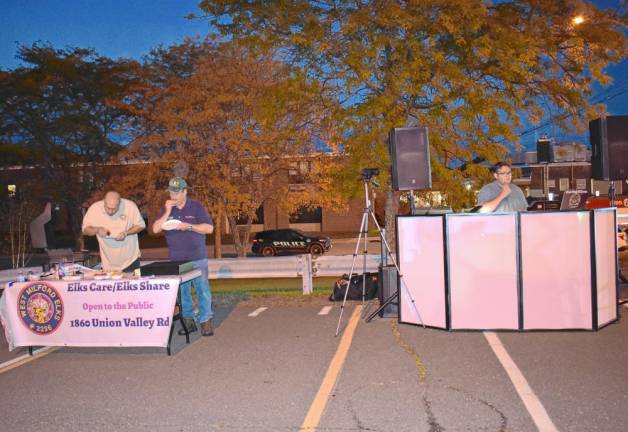 Members of the Elks Club grill hotdogs and hamburgers.