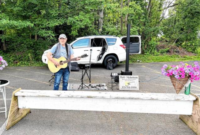 Musician Bob Nicholson plays rock standards at opening day of the West Milford Farmer’s Market on Wednesday, June 5.