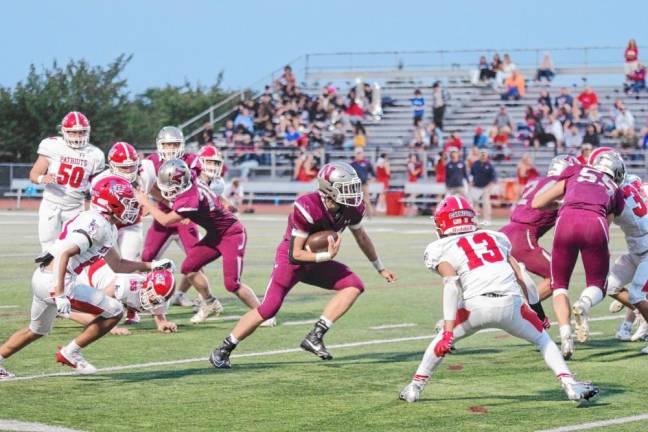 <b>Newton running back Nick Kurilko moves through an opening in the Lenape Valley defense in the first half. The Patriots won, 19-7, on Friday, Sept. 13.</b>