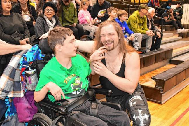 TW1 Mikey Moscatello of West Milford meets ‘The Revolver’ Alex Reiman, a wrestler taking part in the Thanksgiving Thunder fundraiser Saturday, Nov. 23 at West Milford High School. (Photo by Maria Kovic)