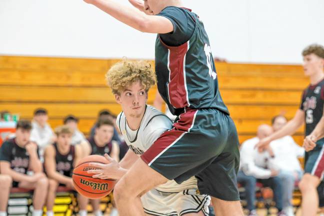 John DelVecchio of West Milford looks to his left for a cutting teammate around the defense of Justin Graves of Wayne Hills.