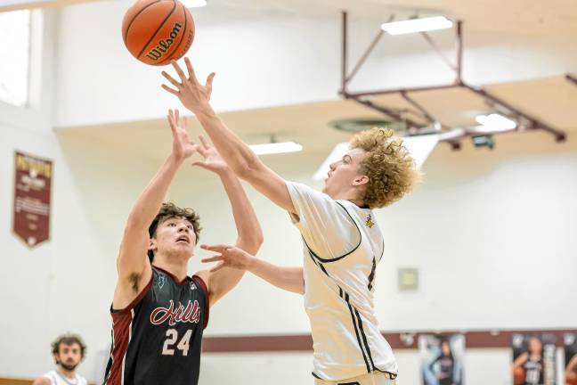 West Milford’s John DelVecchio, right, lets go of a lefty layup during a third-quarter possession in the Passaic County Tournament quarterfinal game. Defending for Wayne Hills is Brooklyn Jelinsky. The game was Saturday, Feb. 15 at Wayne Hills. (Photos by Glenn Clark)