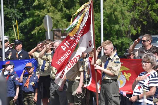 WMP11 Boy Scouts and members of the audience salute during the Memorial Day ceremony.