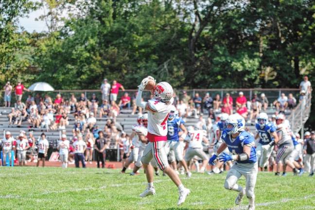 <b>High Point wideout Caden Nardone catches the ball while shadowed by Kittatinny defensive back Niko Martinez in the second half. The Wildcats defeated the Cougars, 36-21, in their third win in a row. (Photos by George Leroy Hunter)</b>