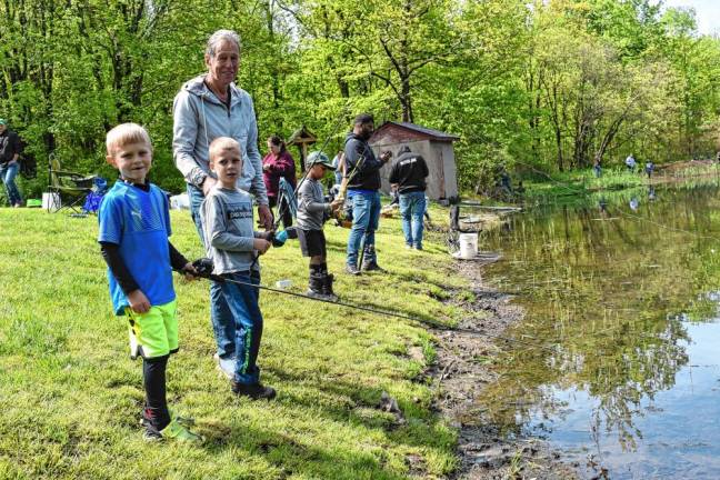 John Arnell with his grandsons Henry Arnell and Ben Hlavack take part in the Trout Fishing Derby on Saturday, May 11.