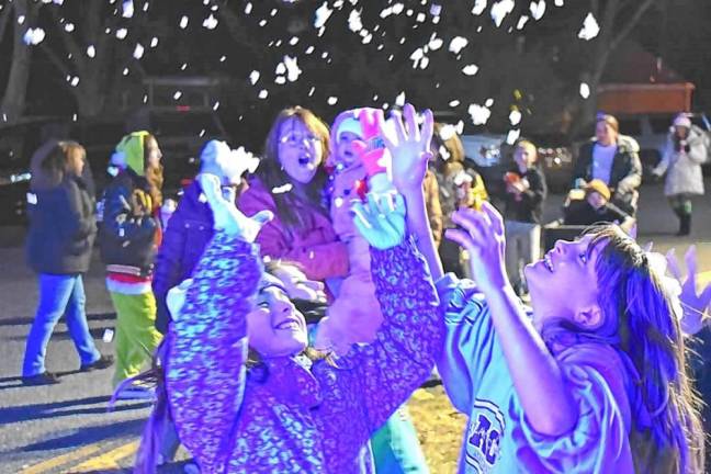 Children catch flakes from the snow-making machines at the annual Christmas Tree Lighting Ceremony on Monday, Dec. 2 in front of the West Milford municipal building. (Photos by Rich Adamonis)