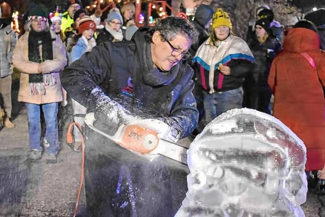 An ice carver at work at the annual tree lighting ceremony.