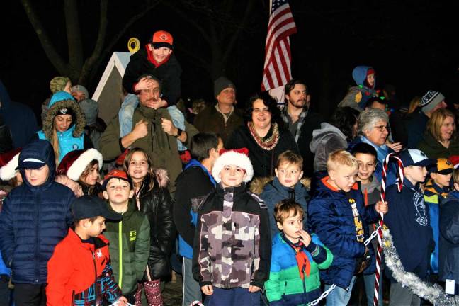 Children from the town sing carols during the tree lighting ceremony Monday night.