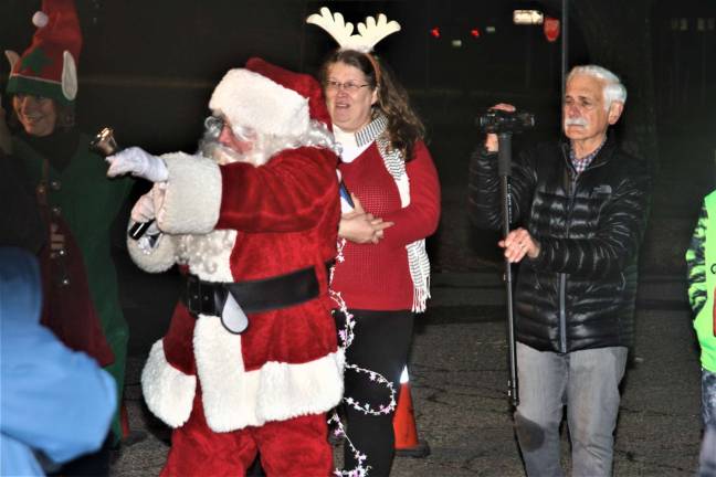 Santa Claus arrives during the tree lighting ceremony Monday night.
