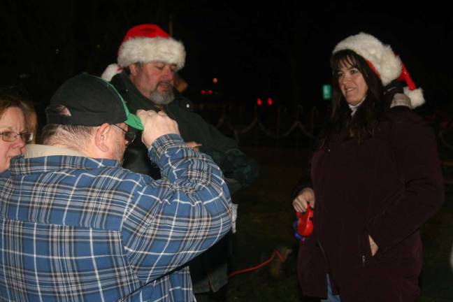 Victor and Denise Stanich take part in the holiday happenings with their dog, &#x201c;Binky,&#x201d; at the tree lighting ceremony Monday night.