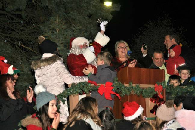 Santa Claus helps Mayor Michele Dale light the town's Christmas Tree Monday night.