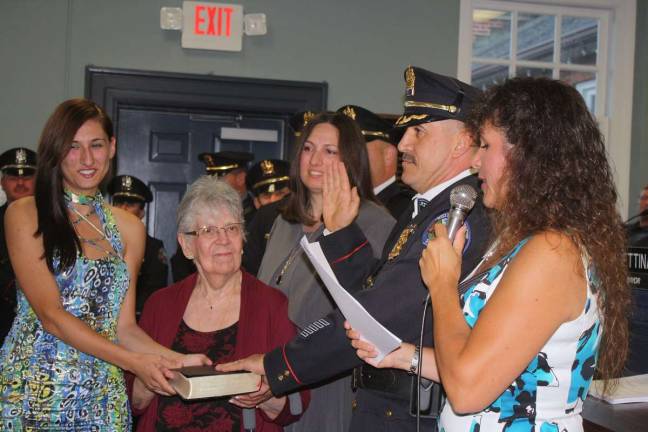 Police Chief Timothy C. Storbeck took his oath of office while his daughter, Raidi, wife Debra and his mother assisted in his swearing in ceremony. Mayor Bettina Bieri, right, administers the oath.